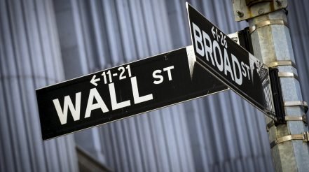 Street signs for Wall St. and Broad St. hang at the corner outside the New York Stock Exchange